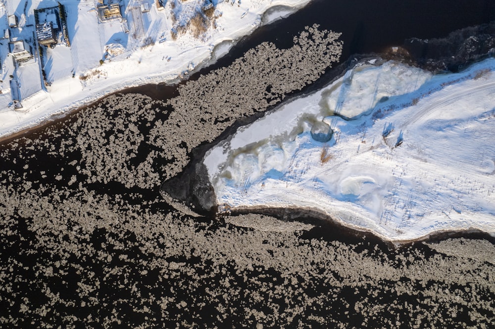 an aerial view of snow covered mountains and a river