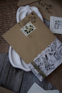 A collection of bespoke paper keepsakes laid out on a rustic wooden table.