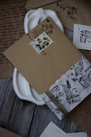 A close-up of handwritten letters and vintage documents spread out on a wooden table.