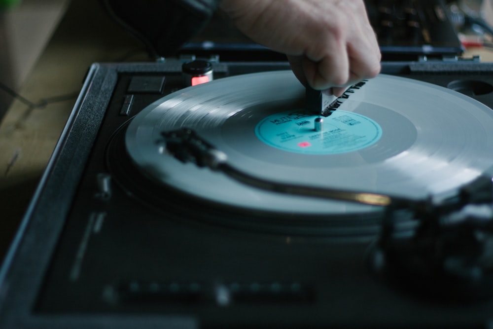 a person using a record player to record a song
