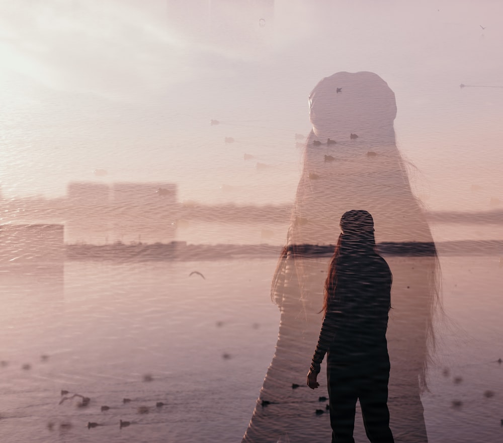 a person standing in front of a body of water