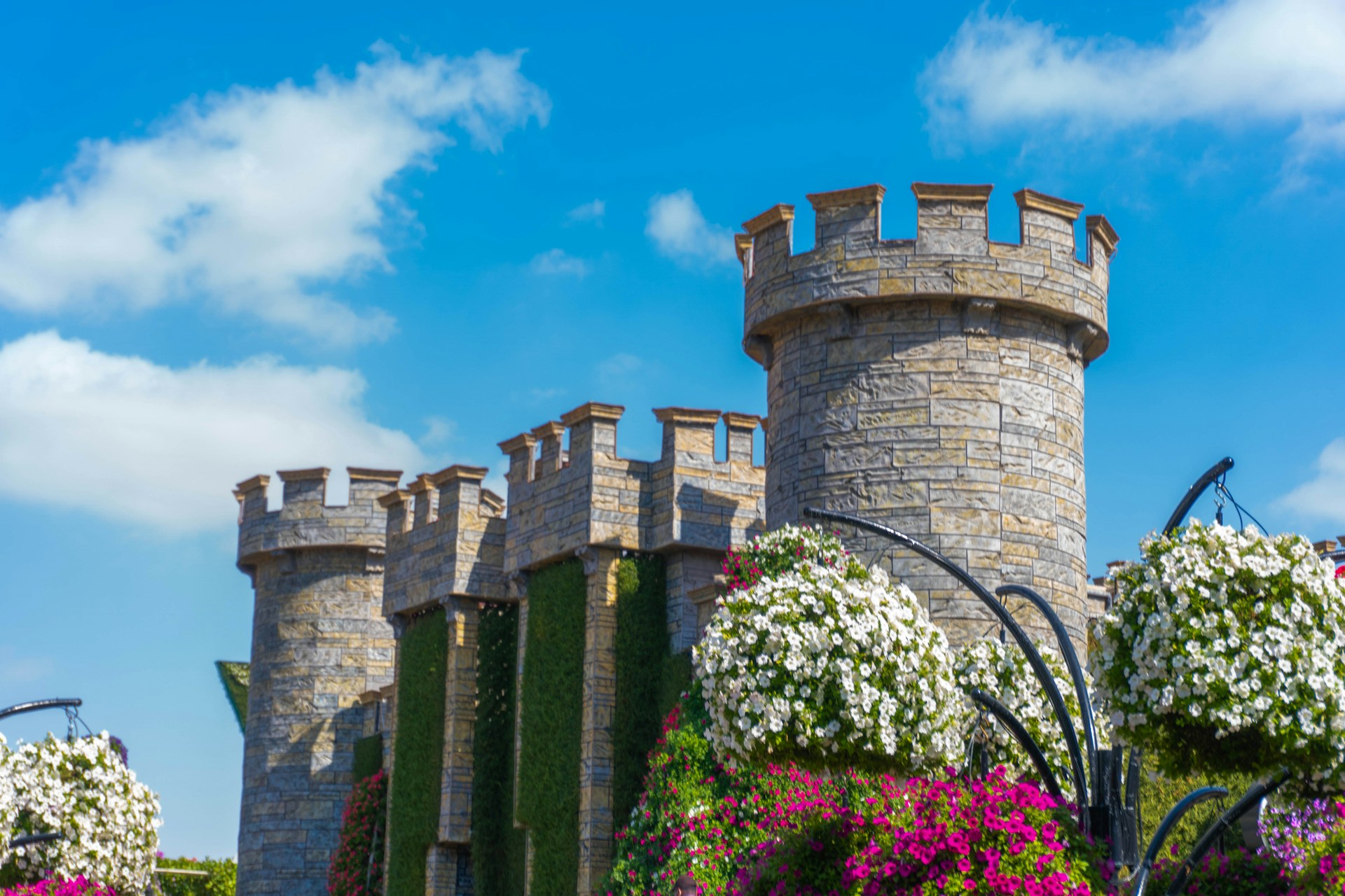 a castle with a lot of flowers in front of it