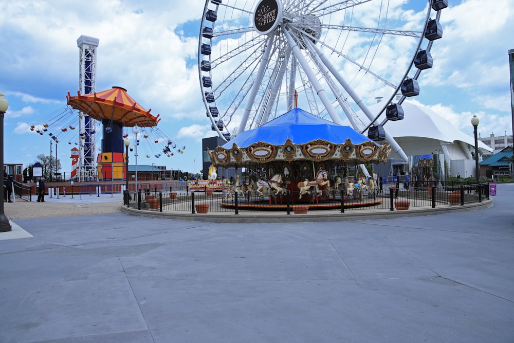 a carnival with a ferris wheel in the background