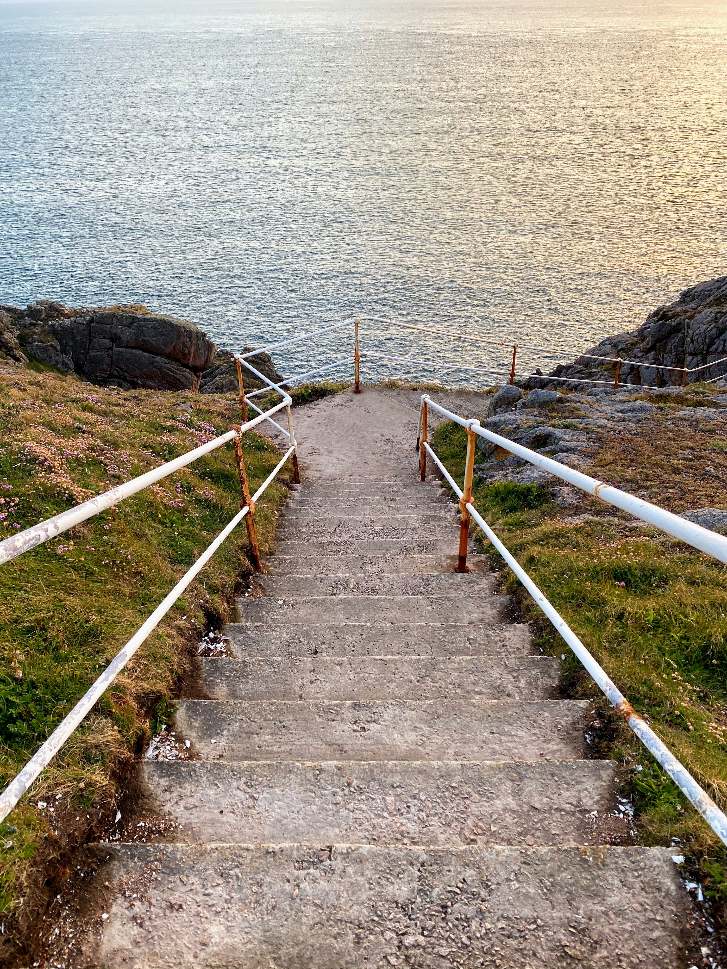 a set of stairs leading down to the ocean