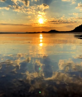 A serene sunset over a tranquil beach, symbolizing peace and reflection.