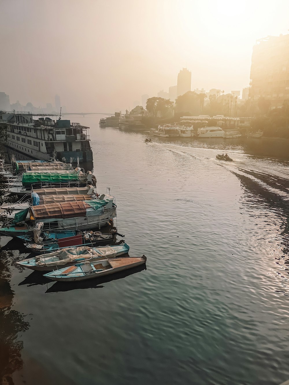 a group of boats floating on top of a river