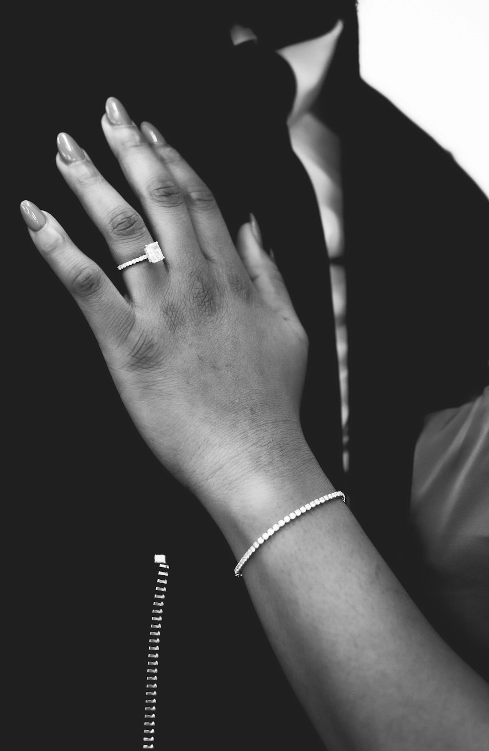 a close up of a person's hand with a ring on it