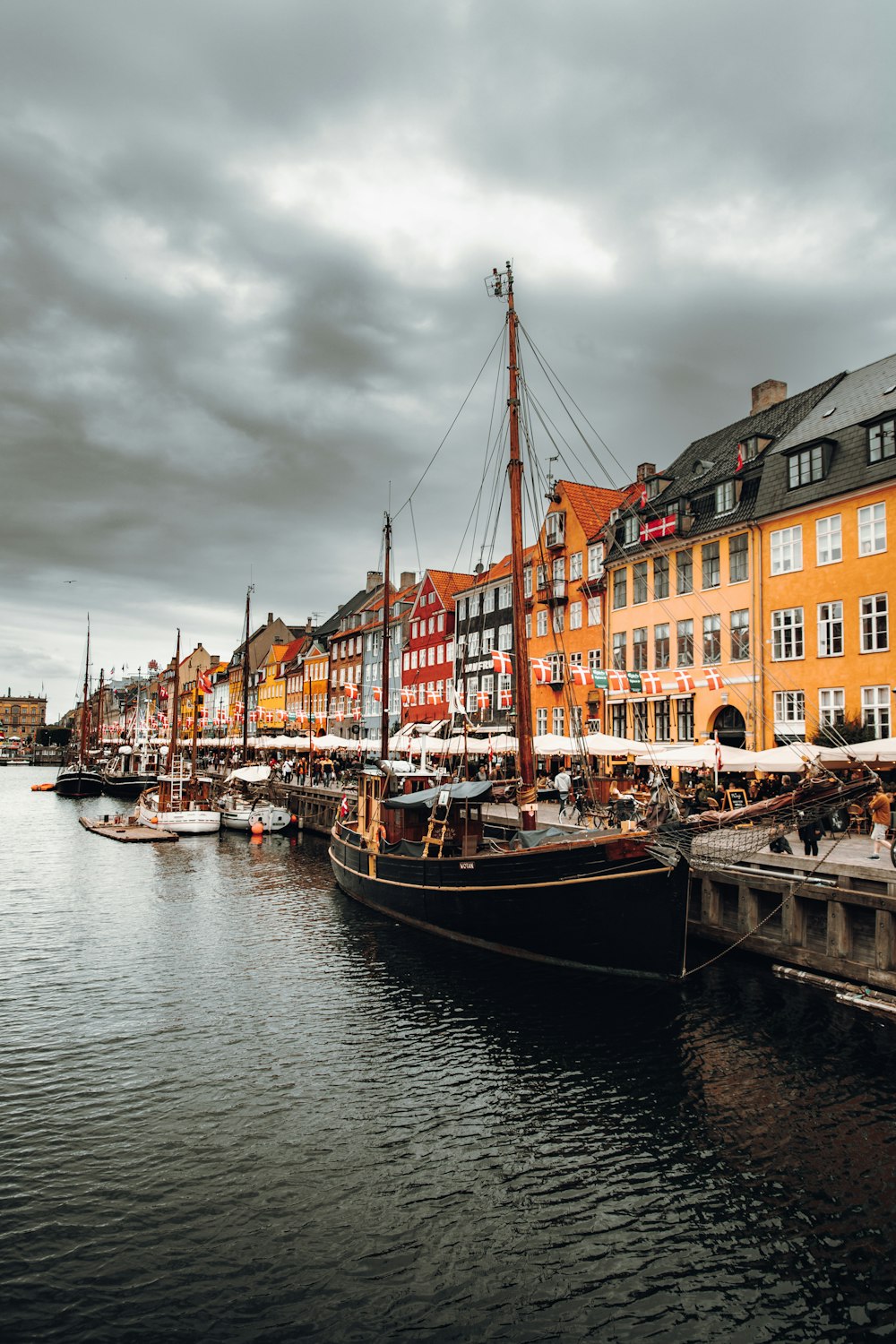 a row of boats sitting next to each other on a body of water