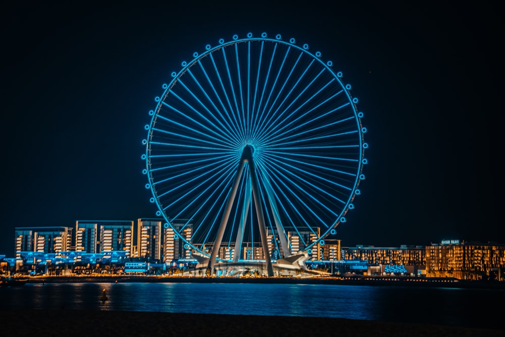 a ferris wheel lit up in the night sky