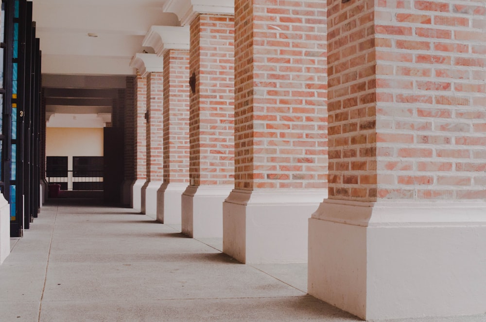 a row of brick pillars next to a building
