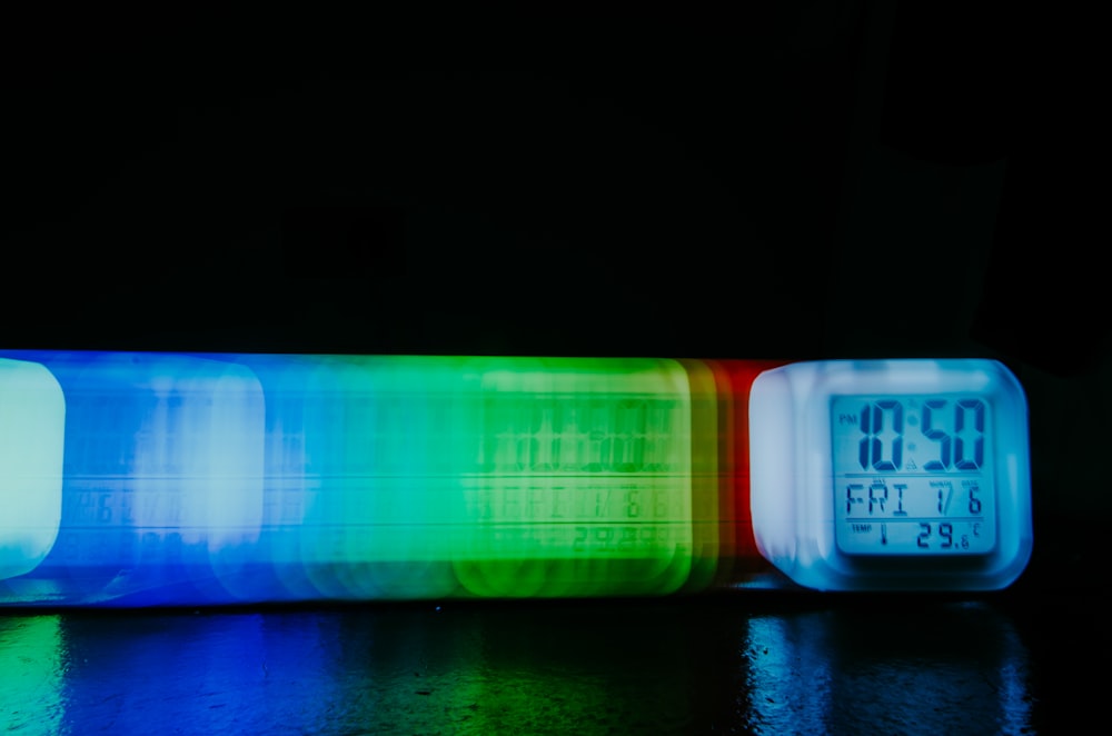 a multicolored clock sitting on top of a table