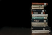 a stack of books sitting on top of a wooden table