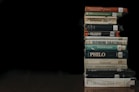 a stack of books sitting on top of a wooden table