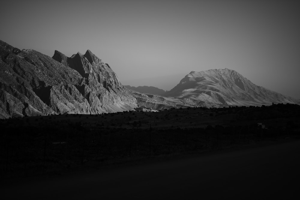 a black and white photo of a mountain range