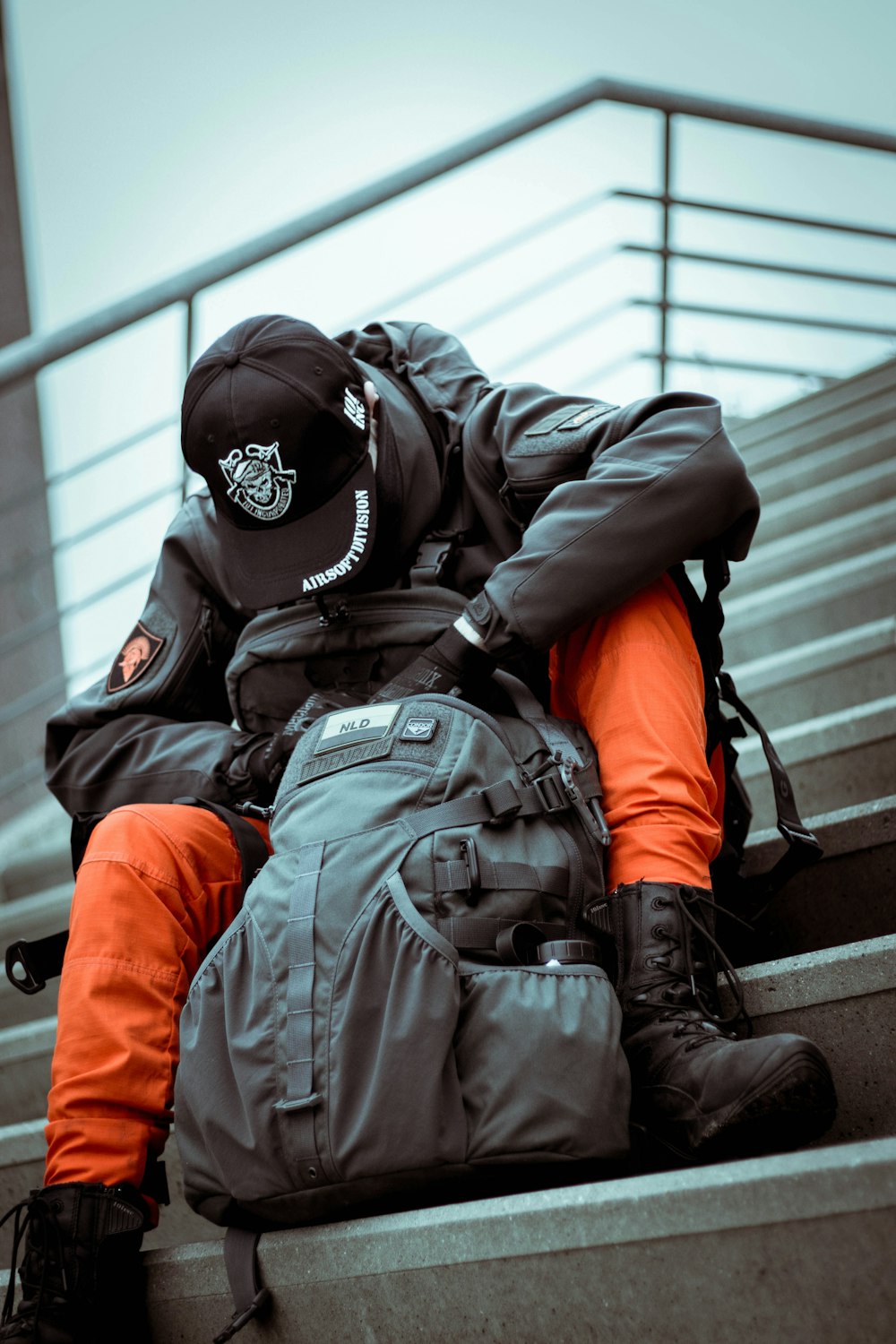 a person with a backpack sitting on some stairs