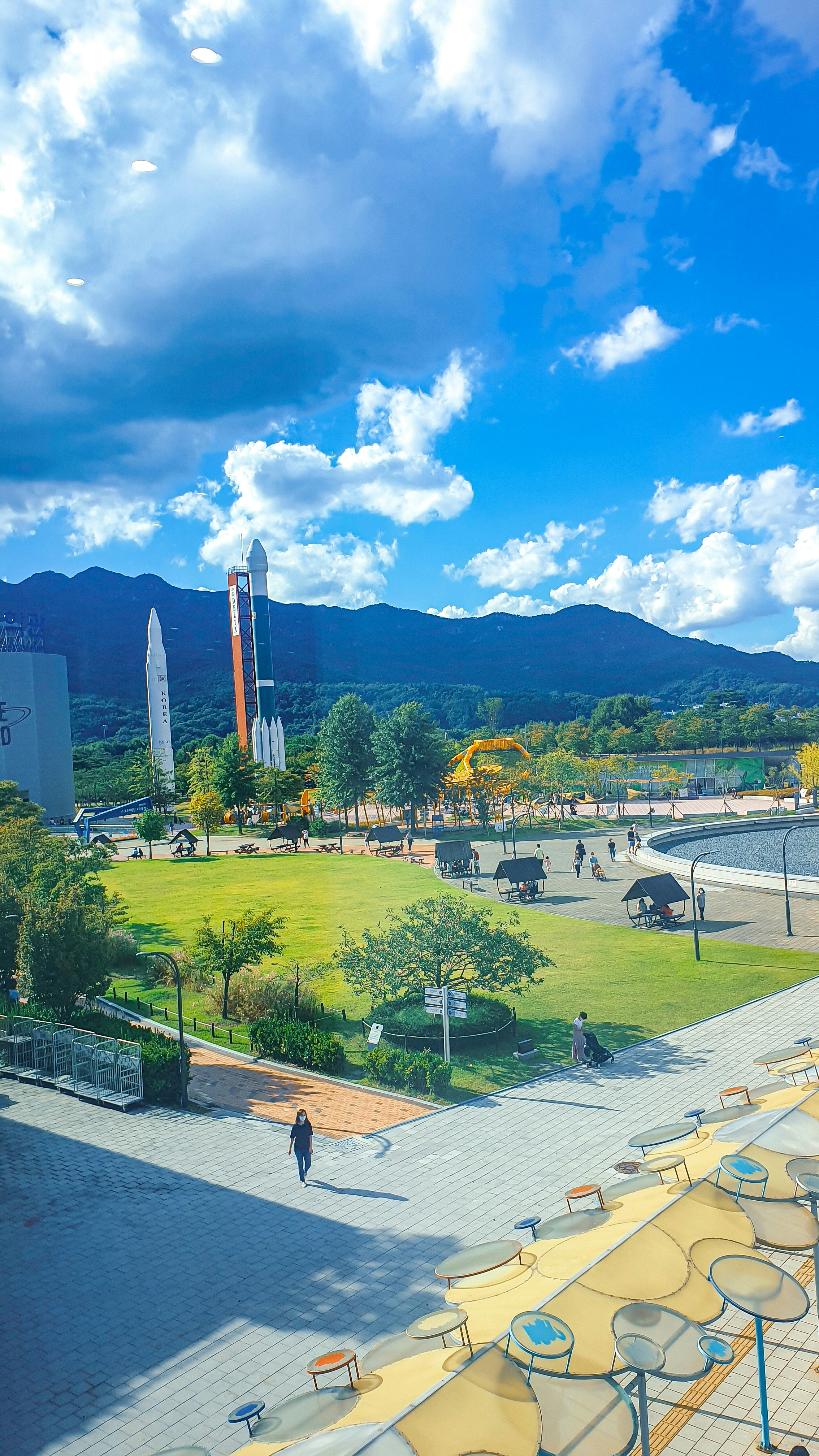 a view of a park with a lot of tables and chairs