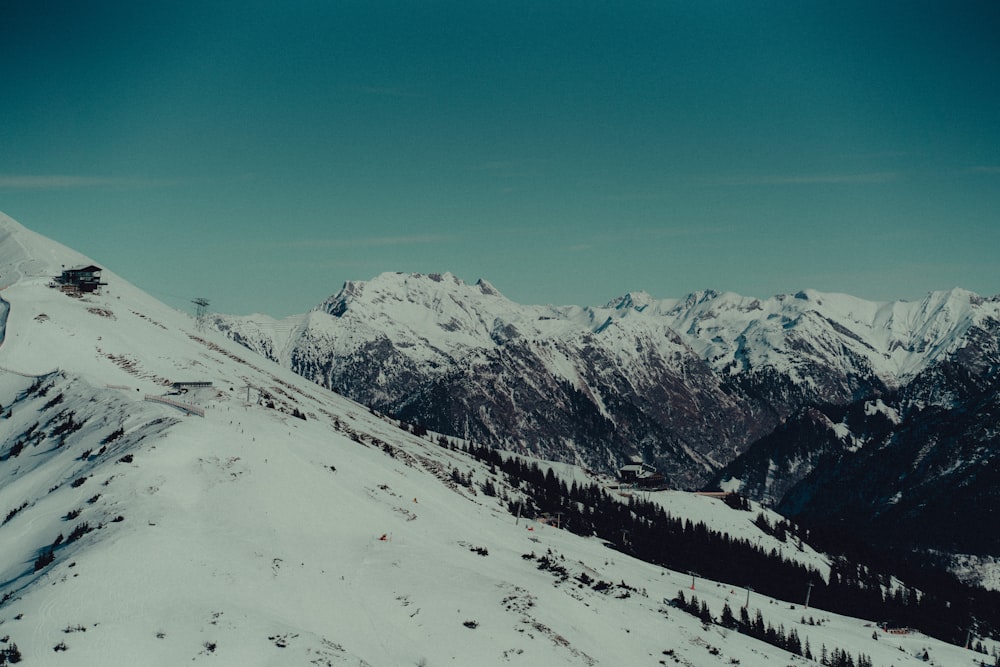 a person riding a snowboard down a snow covered slope