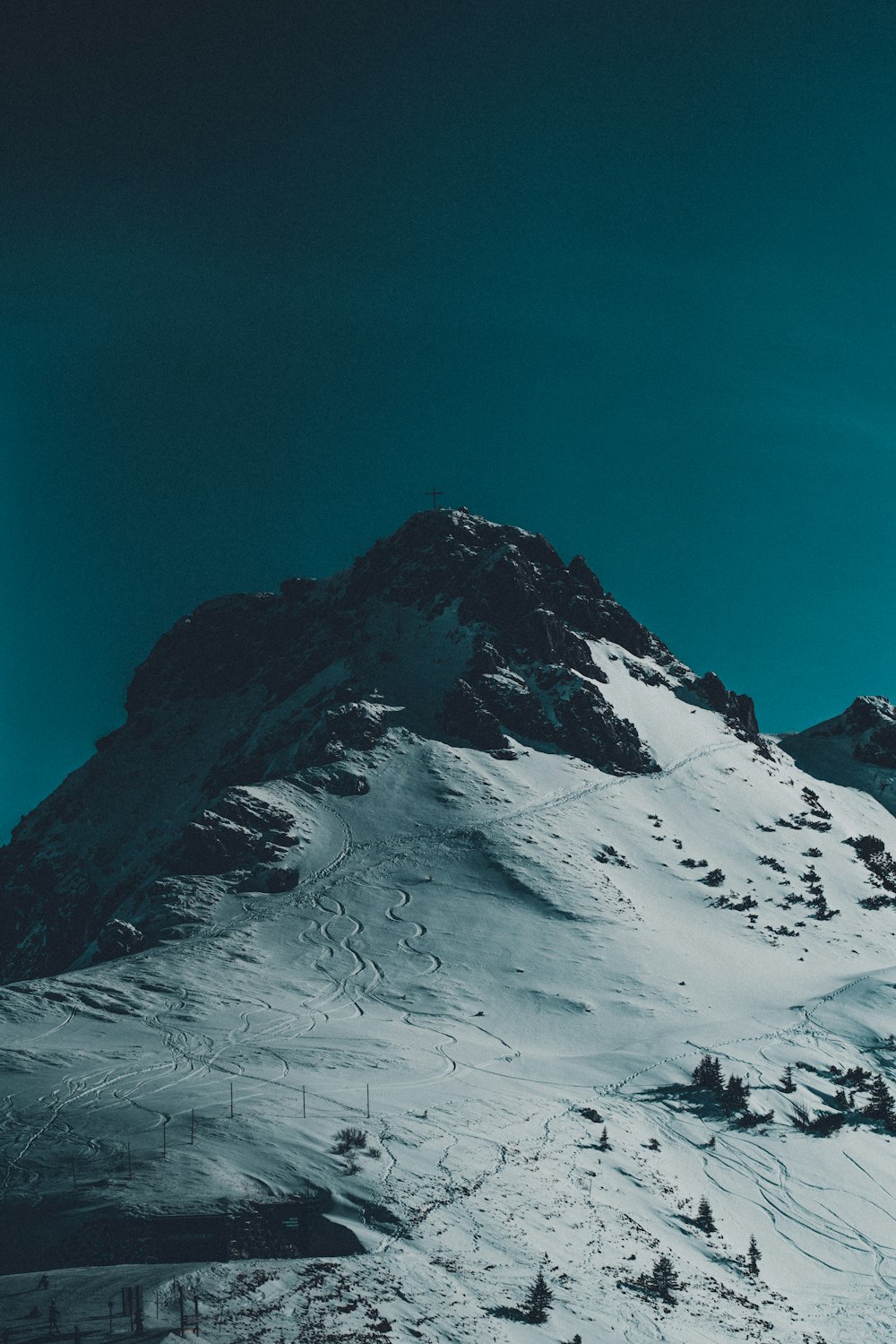 a mountain covered in snow under a blue sky