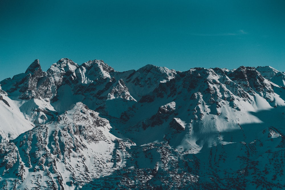 a view of a snowy mountain range from a plane