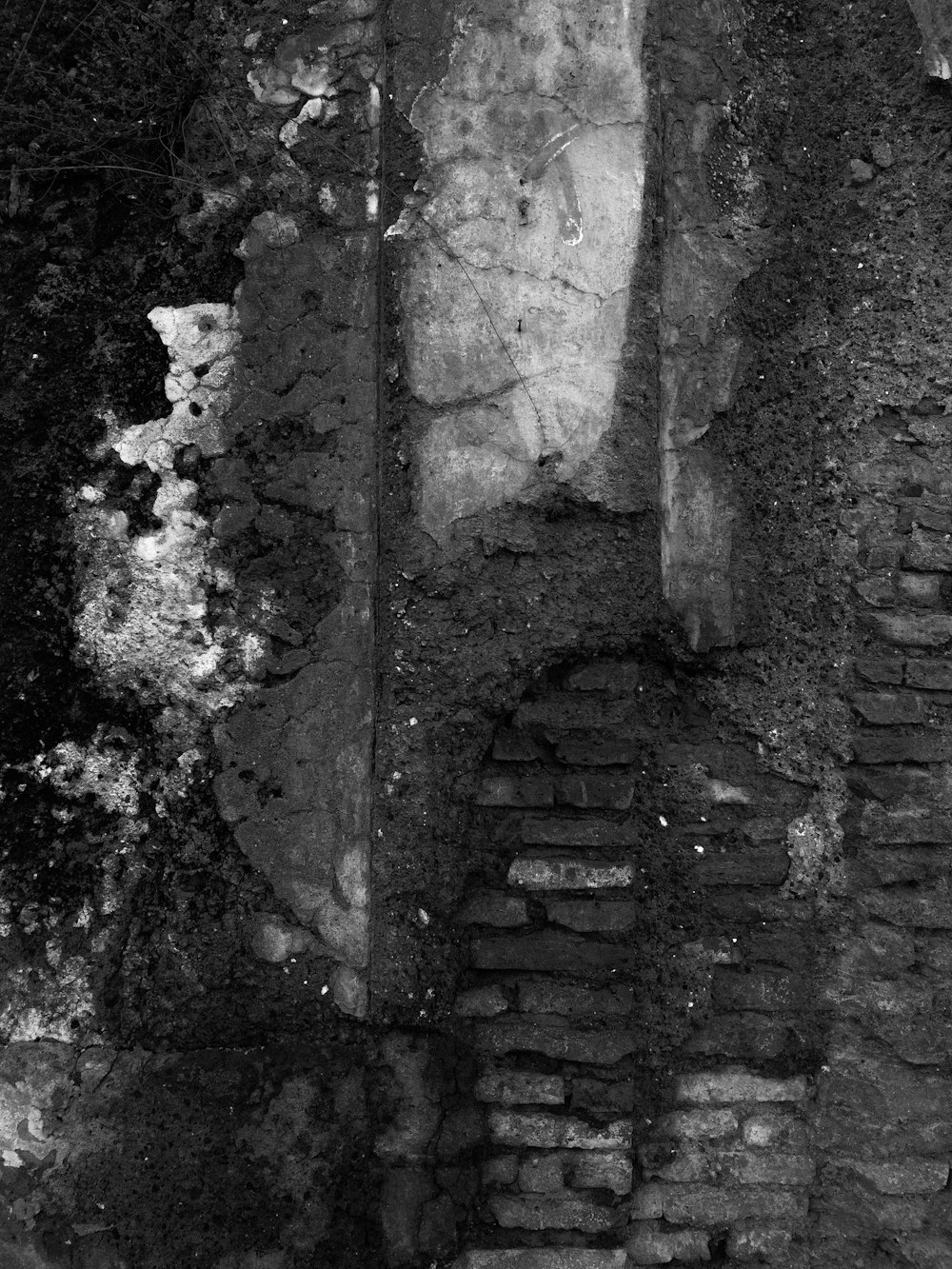 a black and white photo of a brick wall