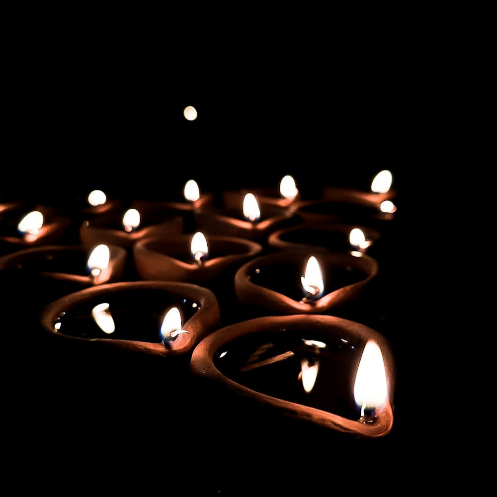a group of lit candles in the dark