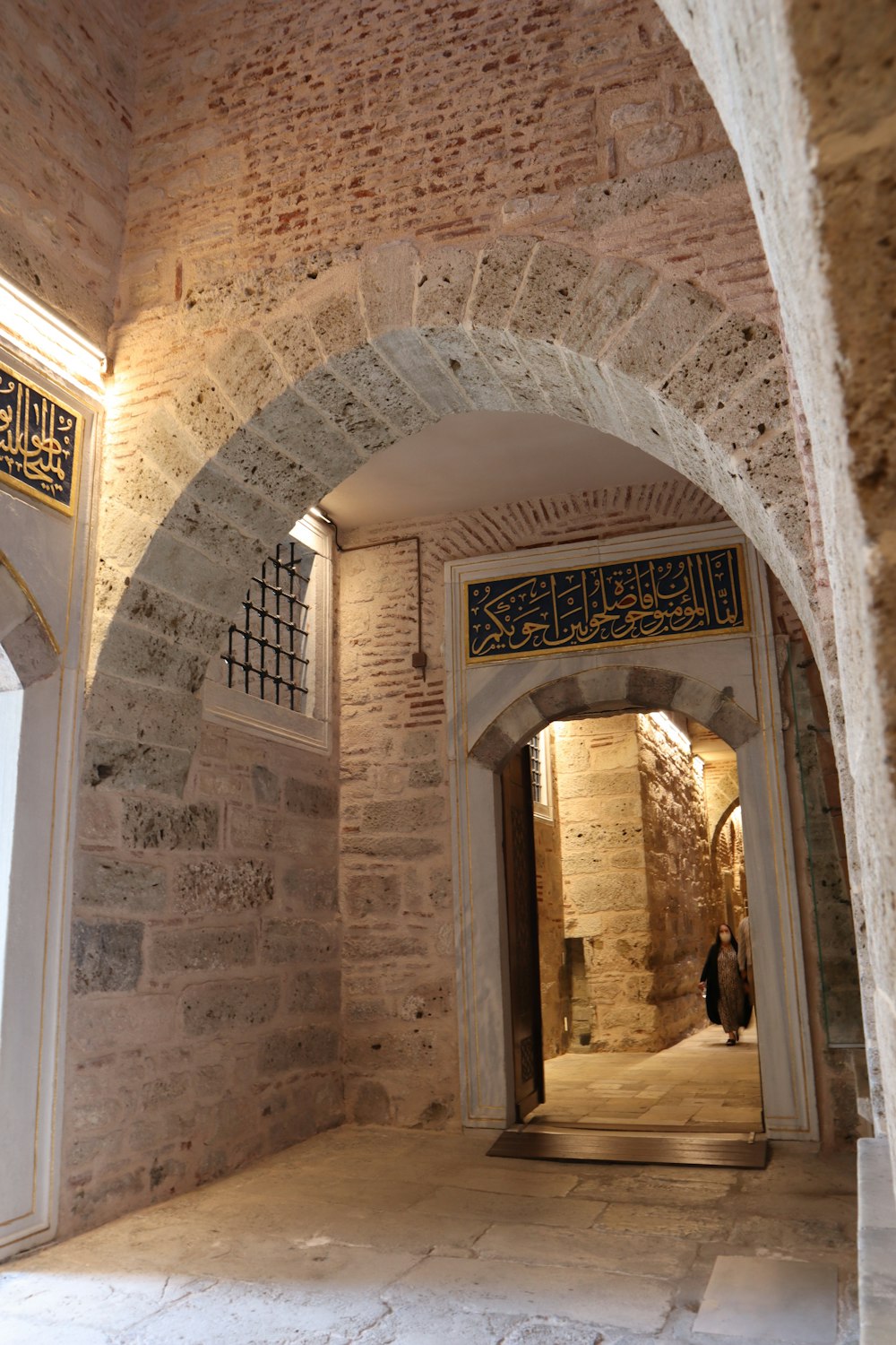 a person is walking through an archway in a building