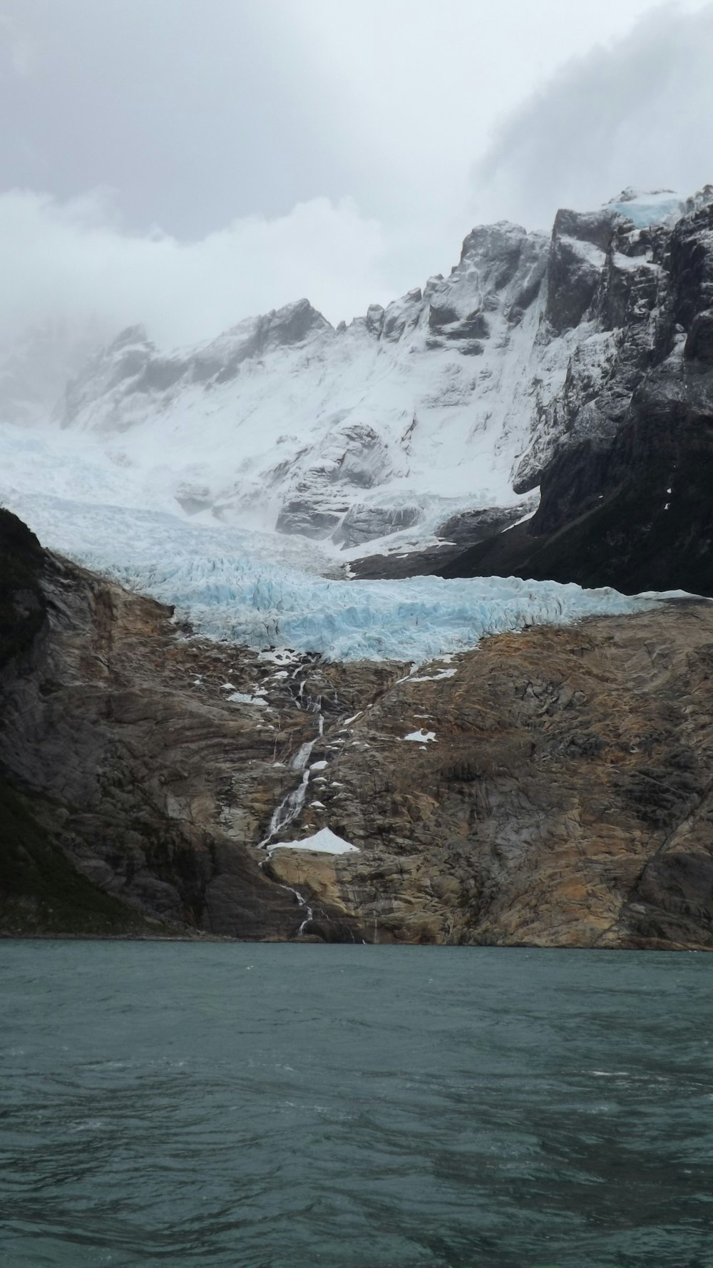 a large glacier with a mountain in the background