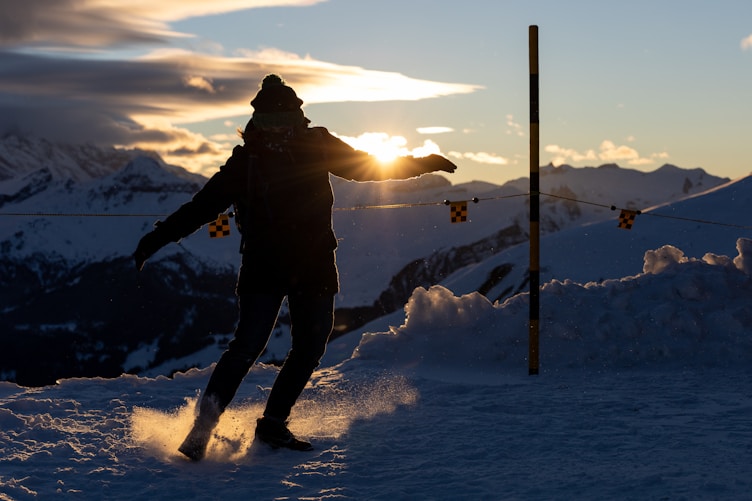 a man riding skis down a snow covered slope