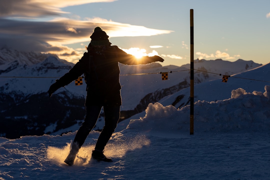 a man riding skis down a snow covered slope,