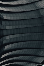 Side-by-side view of a 3D CAD model and the completed aluminum facade on site.