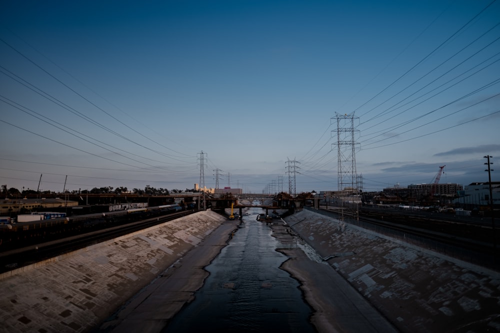 a train traveling down train tracks next to power lines