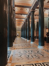 a large room with columns and a tiled floor