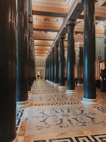 a large room with columns and a tiled floor
