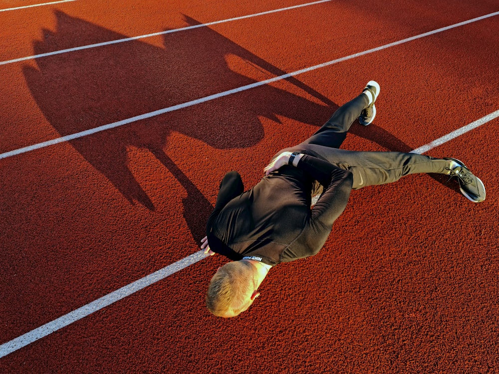 a man in a suit is laying on a track