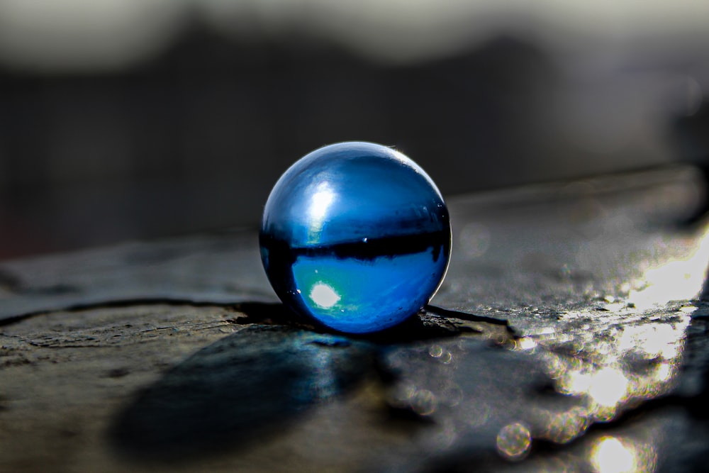 a drop of water sitting on top of a wooden table