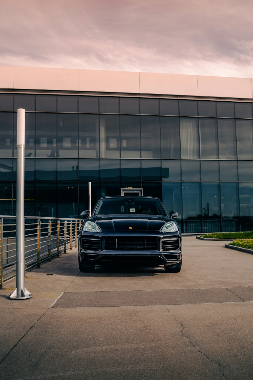 a black sports car parked in front of a building