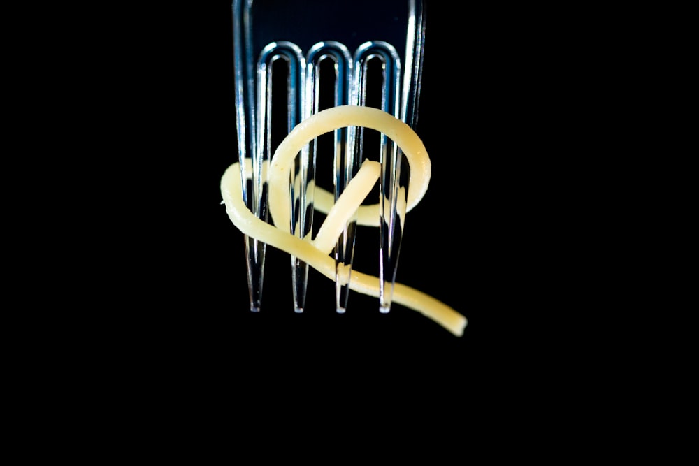 a close up of a pasta cutter on a black background