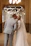 Bride and groom sharing a tender slow-motion kiss under soft blush pink lighting.