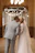 Bride and groom sharing a tender slow-motion kiss under soft blush pink lighting.