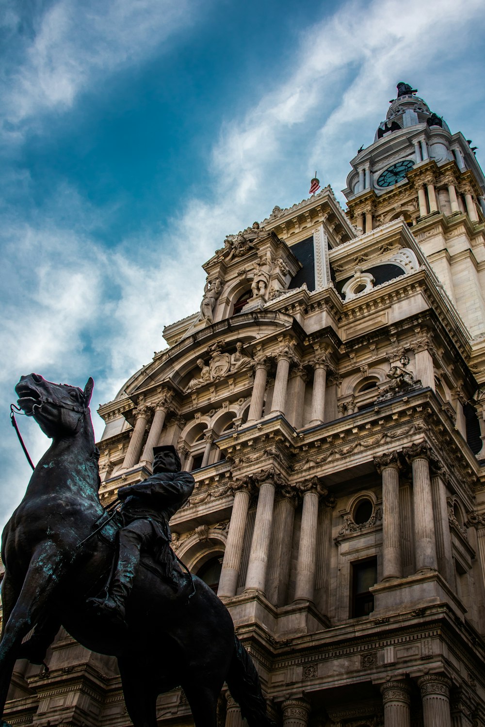 a statue of a man on a horse in front of a building