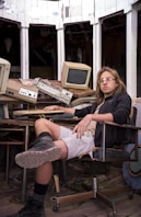 a man sitting in a chair in front of a computer