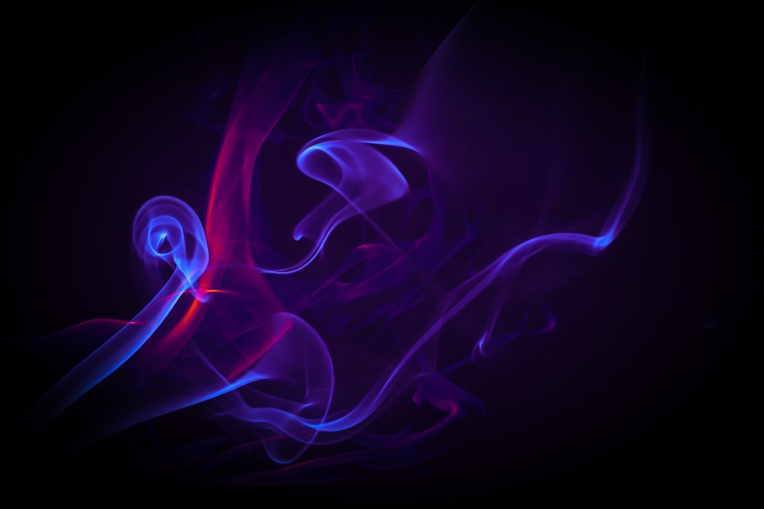 a purple and blue smoke swirl on a black background