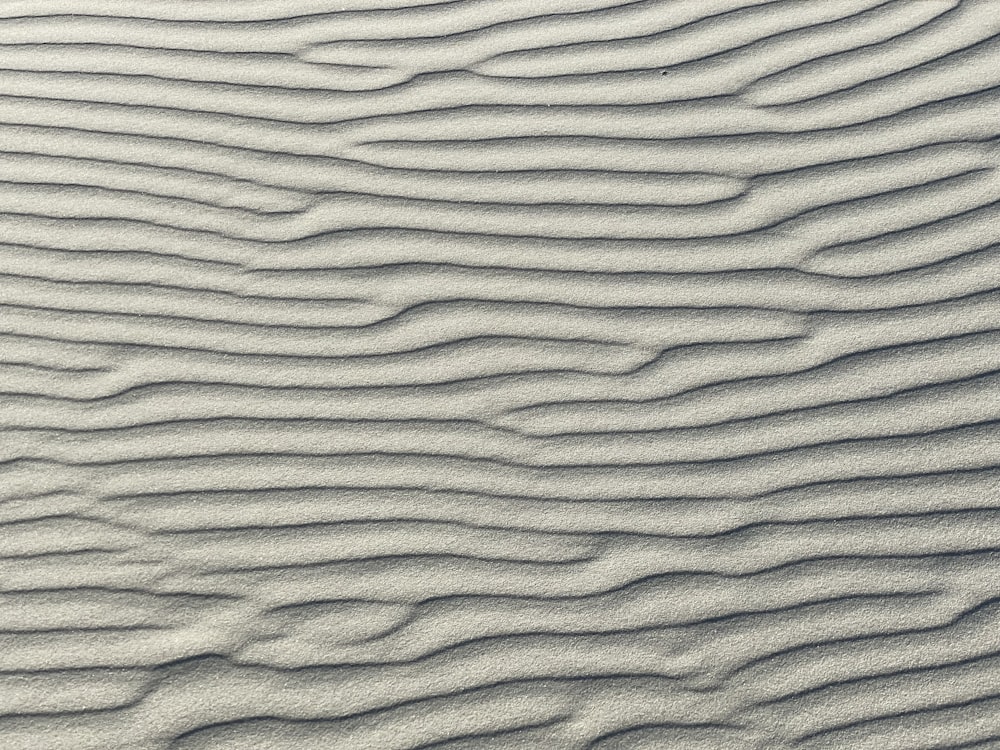 a close up of a sand dune with wavy lines