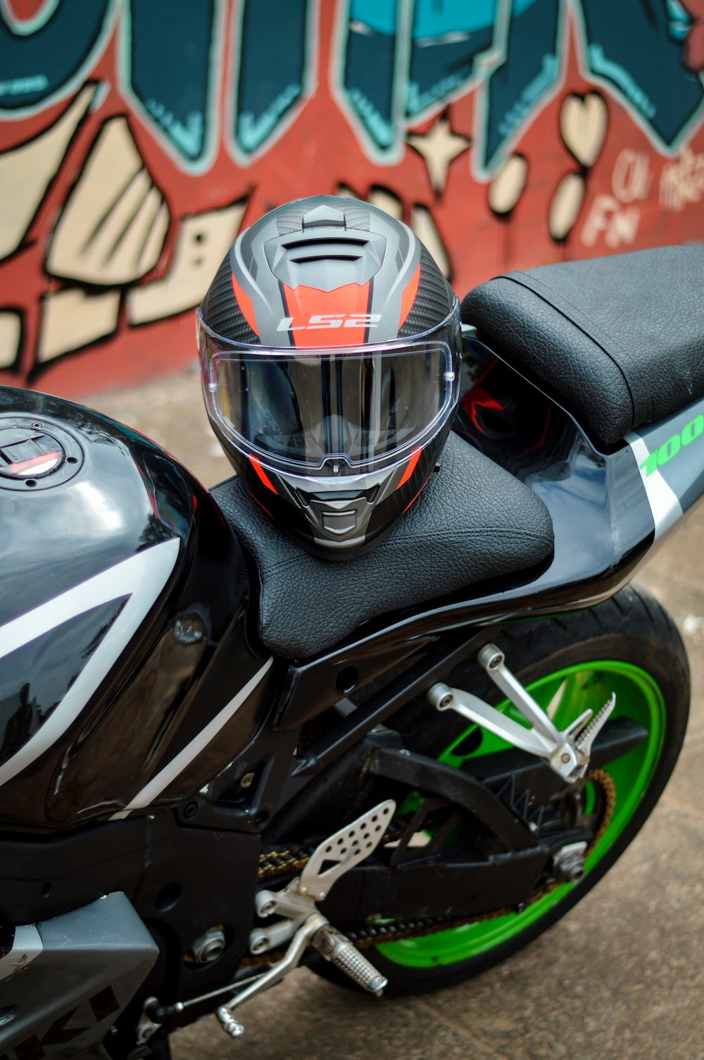 a motorcycle parked in front of a graffiti covered wall