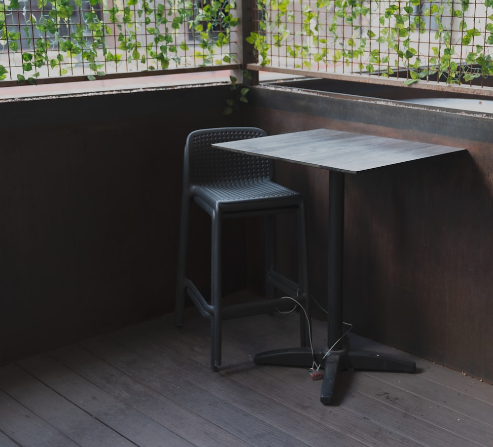 a table and chair on a wooden deck