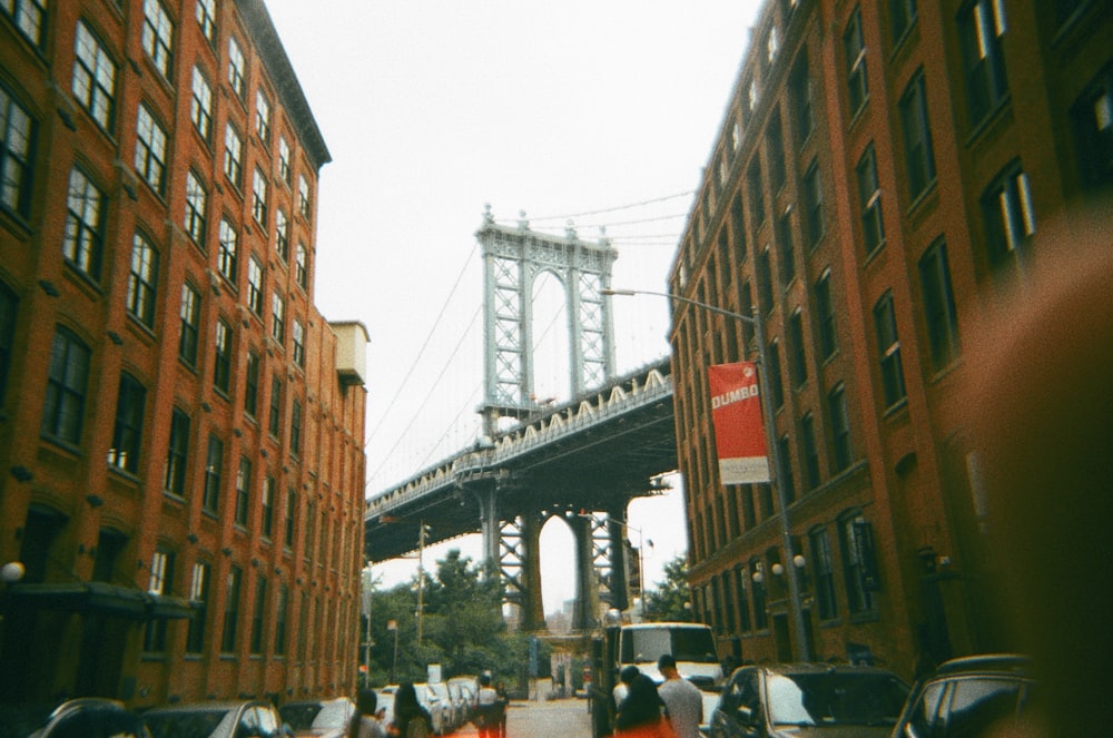 a city street with a bridge in the background