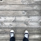 A pair of summer sneakers on a wooden deck.
