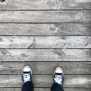 A pair of summer sneakers on a wooden deck.