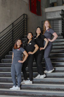 a group of women standing on top of a set of stairs