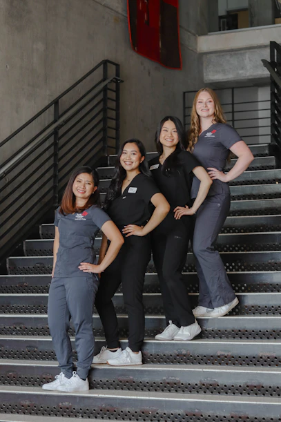 a group of women standing on top of a set of stairs